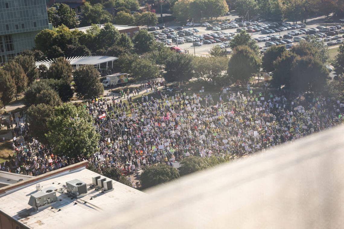 The crowd settles in First Ward Park on Saturday, Oct. 18, for a ‘No Kings’ rally in uptown Charlotte. Hundreds of people showed up to protest policies enacted by President Donald Trump,