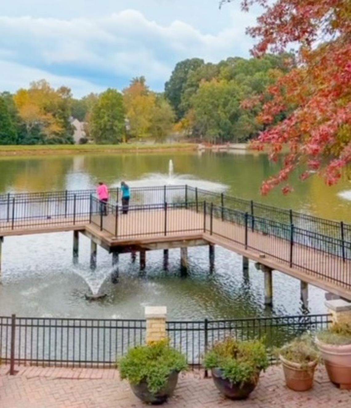 View from the patio at Link & Pin’s Arboretum location, which shows off a private pond with a pier and a water feature.