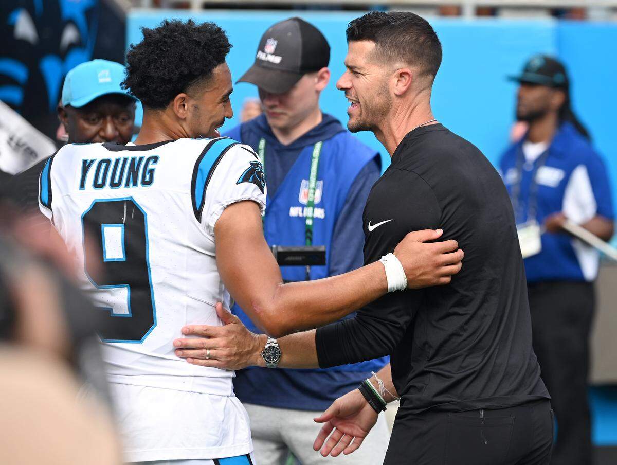Carolina Panthers quarterback Bryce Young and head coach Dave Canales, right, celebrate the team's 27-24 victory over the Miami Dolphins on Sunday, Oct. 5, 2025 at Bank of America Stadium in Charlotte, North Carolina.