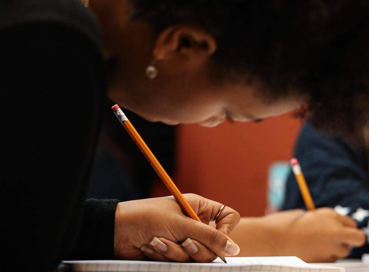 Naomi Rivers, 14, writes from a prompt that was given by an instructor during Inkspill, a writing club for youths ages 12 to 18 who want to engage in creative writing.