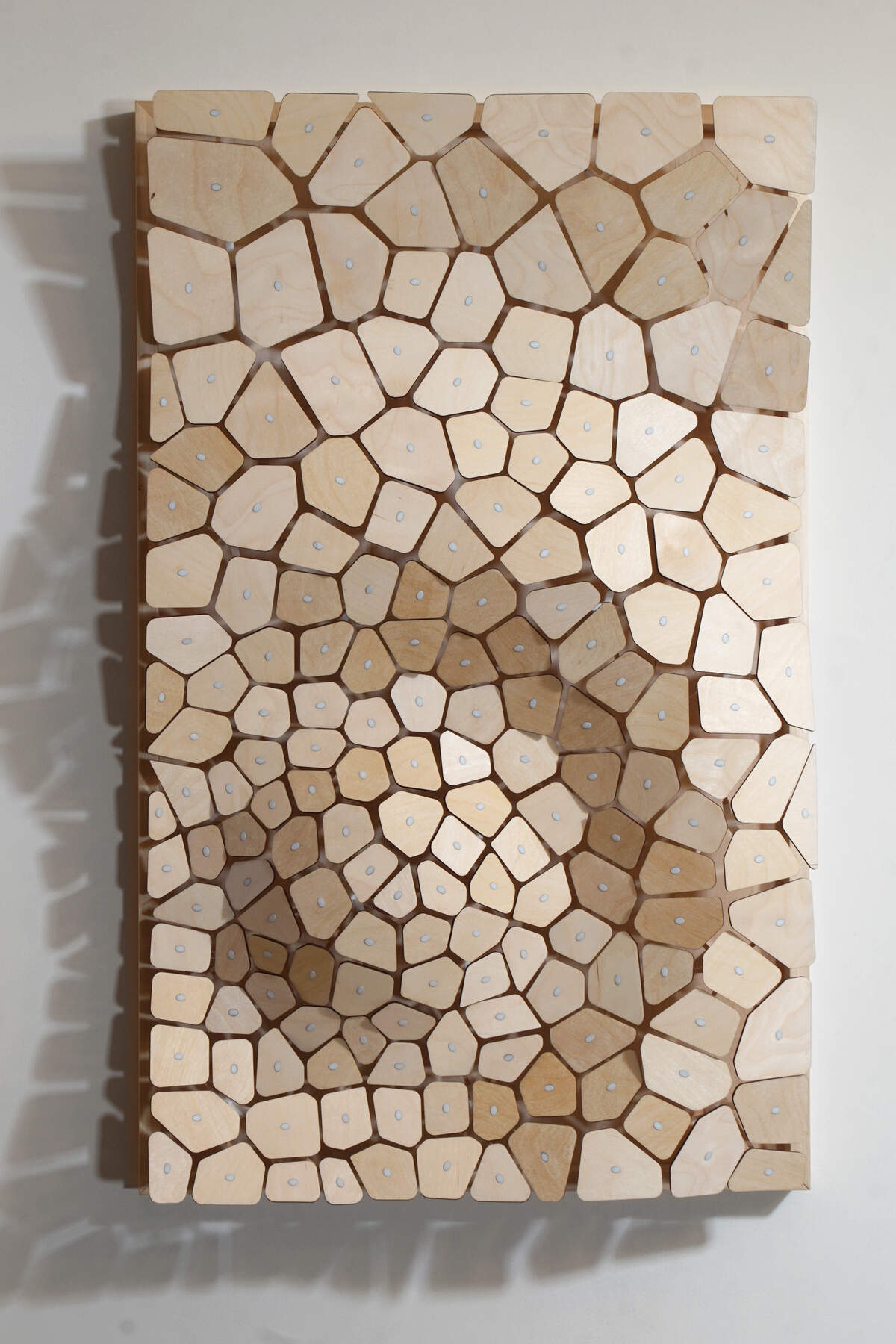 This wall-hanging sculpture by Richard Elaver is titled “Wripple 2.” It’s made of wood and 3D printed resin..