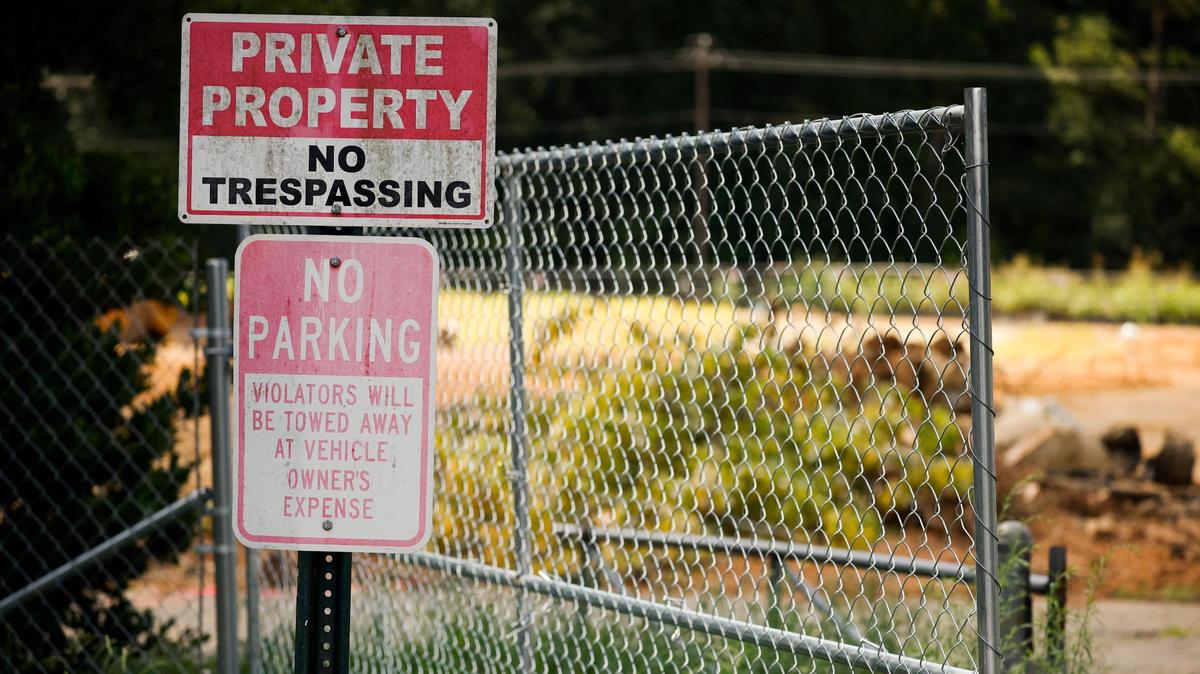 No trespassing signs are posted along the 5800 block of Albemarle Road where a developer is building 128 apartment units. The affordable housing development is set to be finished by next summer.