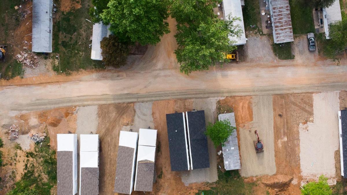 Empty lots, and abandoned mobile homes sit alongside new mobile homes at Countrywoods Mobile Home Park in Charlotte. All current residents of Countrywoods have to leave the park by May 31.