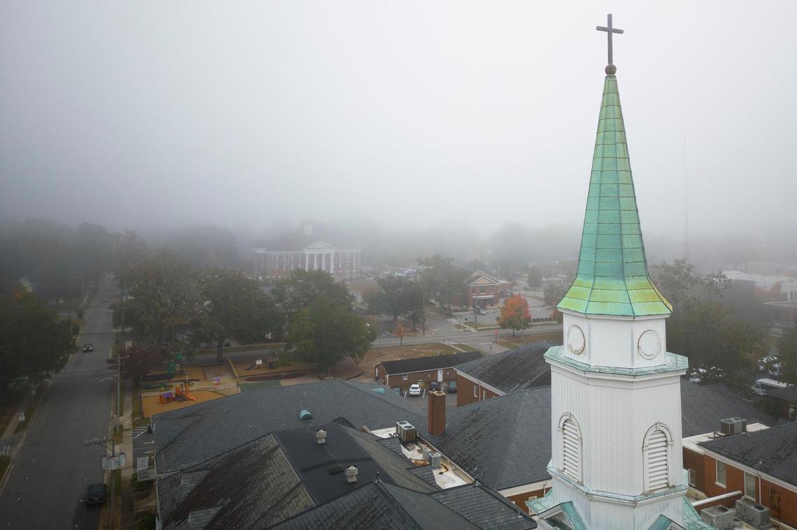 The steeple at First Baptist Church is seen through a blanket of fog in Lumberton, N.C., Wednesday, Oct. 26, 2022.