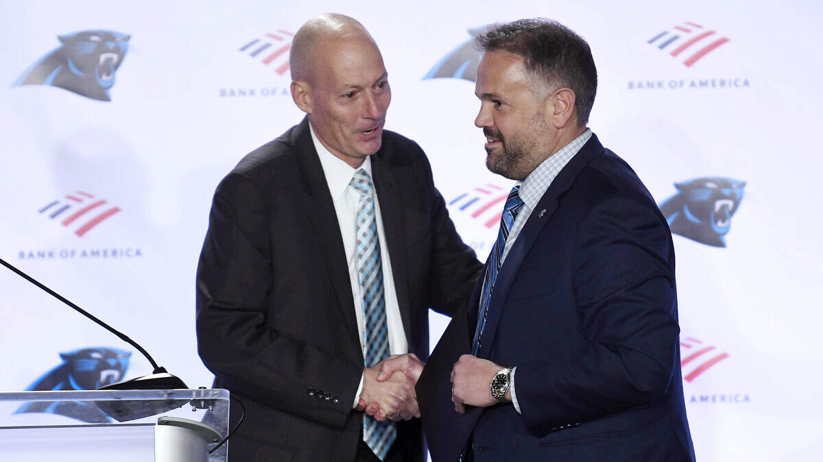 Carolina Panthers play-by-play announcer Mick Mixon, left, introduces new head coach Matt Rhule during a introductory press conference at Atrium Health Dome on Wednesday, January 8, 2020.