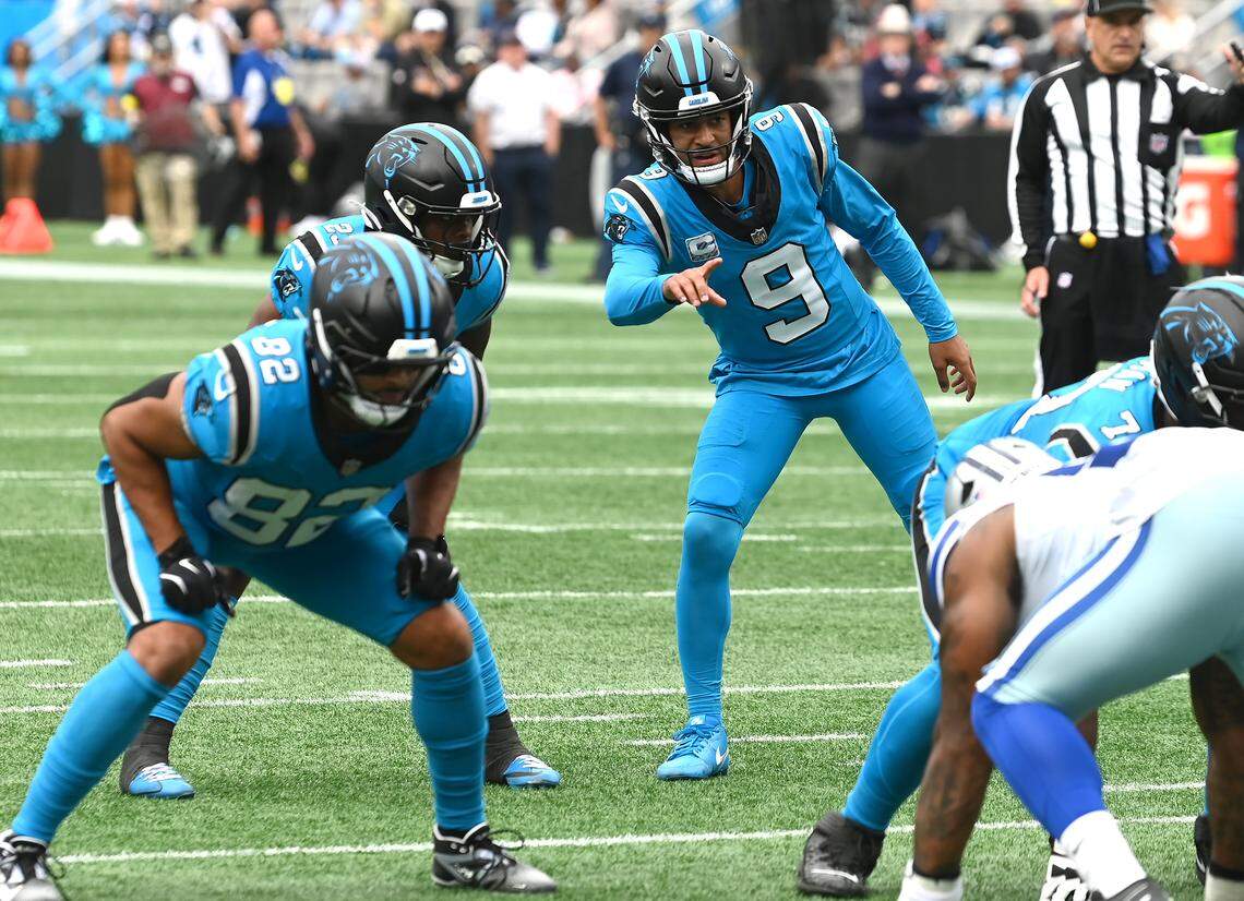 Carolina Panthers quarterback Bryce Young, right, gives instructions to running back Trevor Etienne, left, at the line of scrimmage during action against the Dallas Cowboys on Sunday at Bank of America Stadium. The Panthers defeated the Cowboys 30-27.
