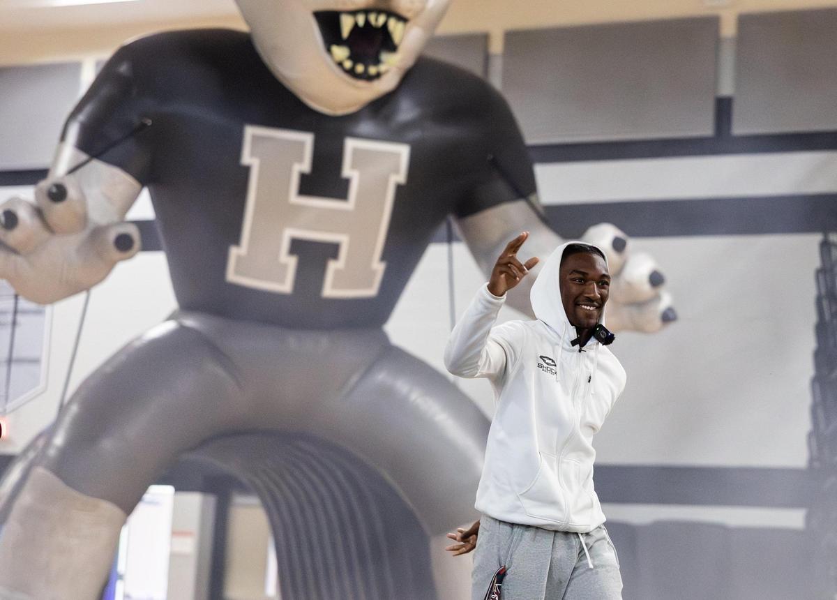 Hough football star Samari “Smoke” Matthews greets the crowd before announcing his college commitment at Hough High School in Cornelius, N.C., on Friday, July 11, 2025.
