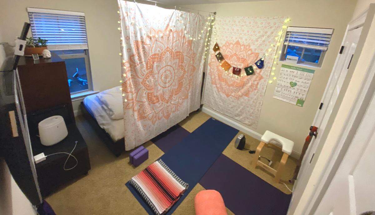 During COVID-19, Melissa Oyler moved her guest room furniture to the corner of the room and is using the rest of the space for an at-home hot yoga studio. Using two space heaters and a warm-mist humidifier, she can get the room heated to 100 degrees and higher.
