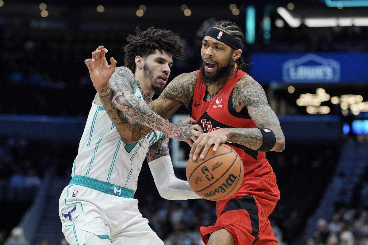 Toronto Raptors forward Brandon Ingram (3) drives to the basket against Charlotte Hornets guard Lamelo Ball (1) during the first half of an NBA basketball game, Wednesday, Jan. 7, 2026, in Charlotte, N.C.