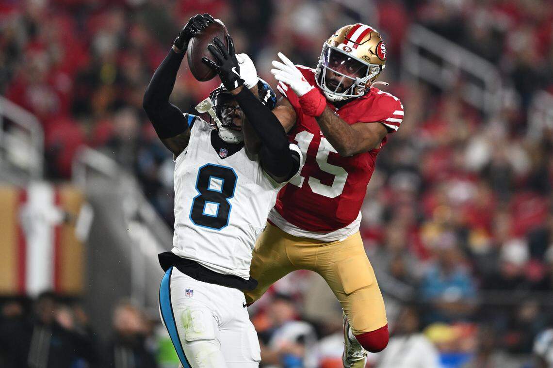 Jaycee Horn (8) of the Carolina Panthers intercepts the pass intended for Jauan Jennings (15) of the San Francisco 49ers in the first quarter of the game at Levi's Stadium on November 24, 2025 in Santa Clara, California.