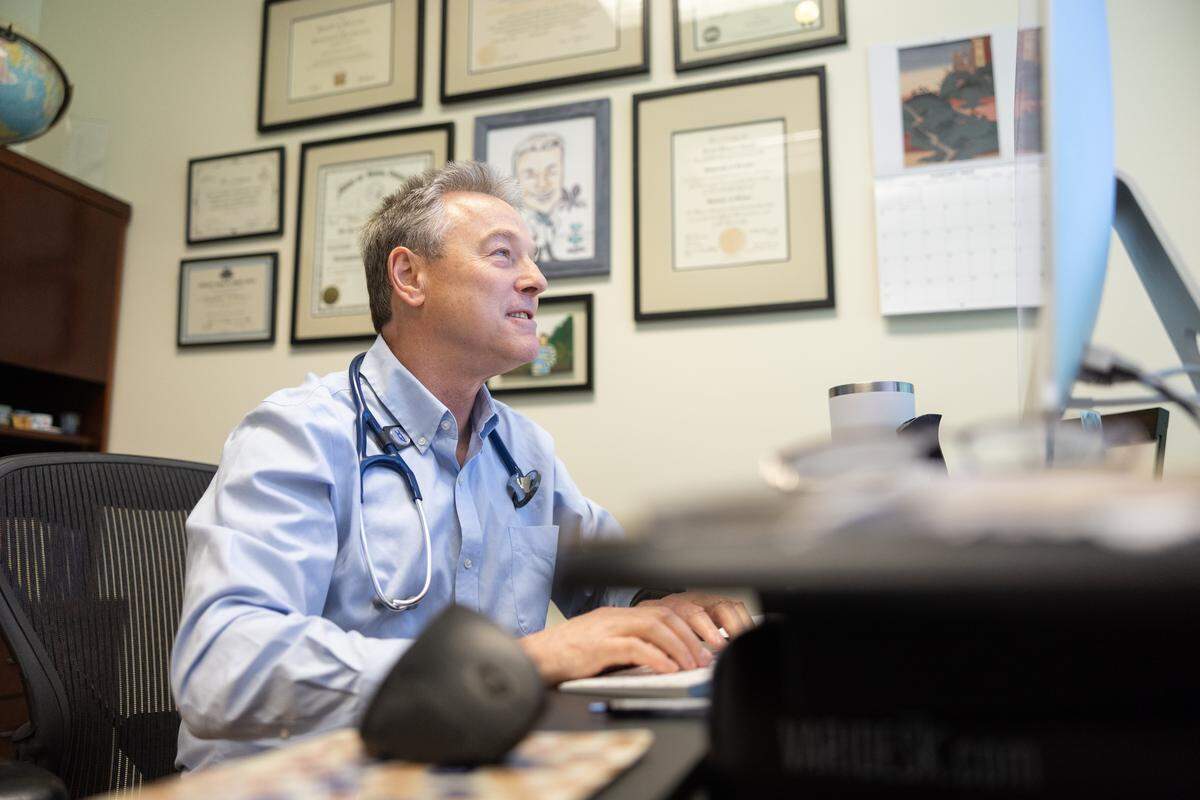 Dr. Jordan Lipton works in his office, where he also sees patients for a portion of exam visits at Signature Healthcare in Charlotte. He specializes in concierge medicine services.