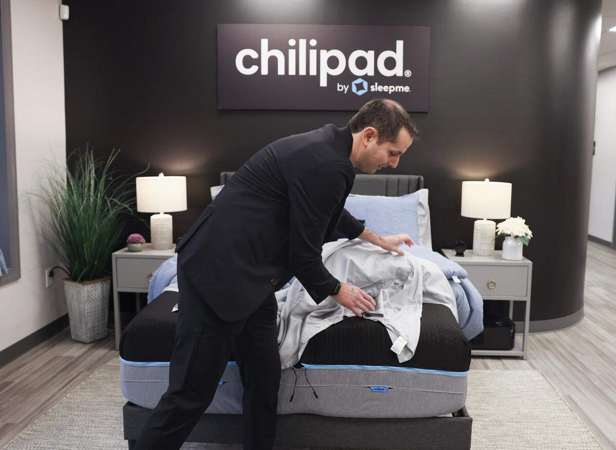 Robbie Falls, chief marketing and product officer of Chilipad by Sleepme, shows how the Chillipad works during a tour of the new Mooresville manufacturing facility on Tuesday, June 2, 2026.