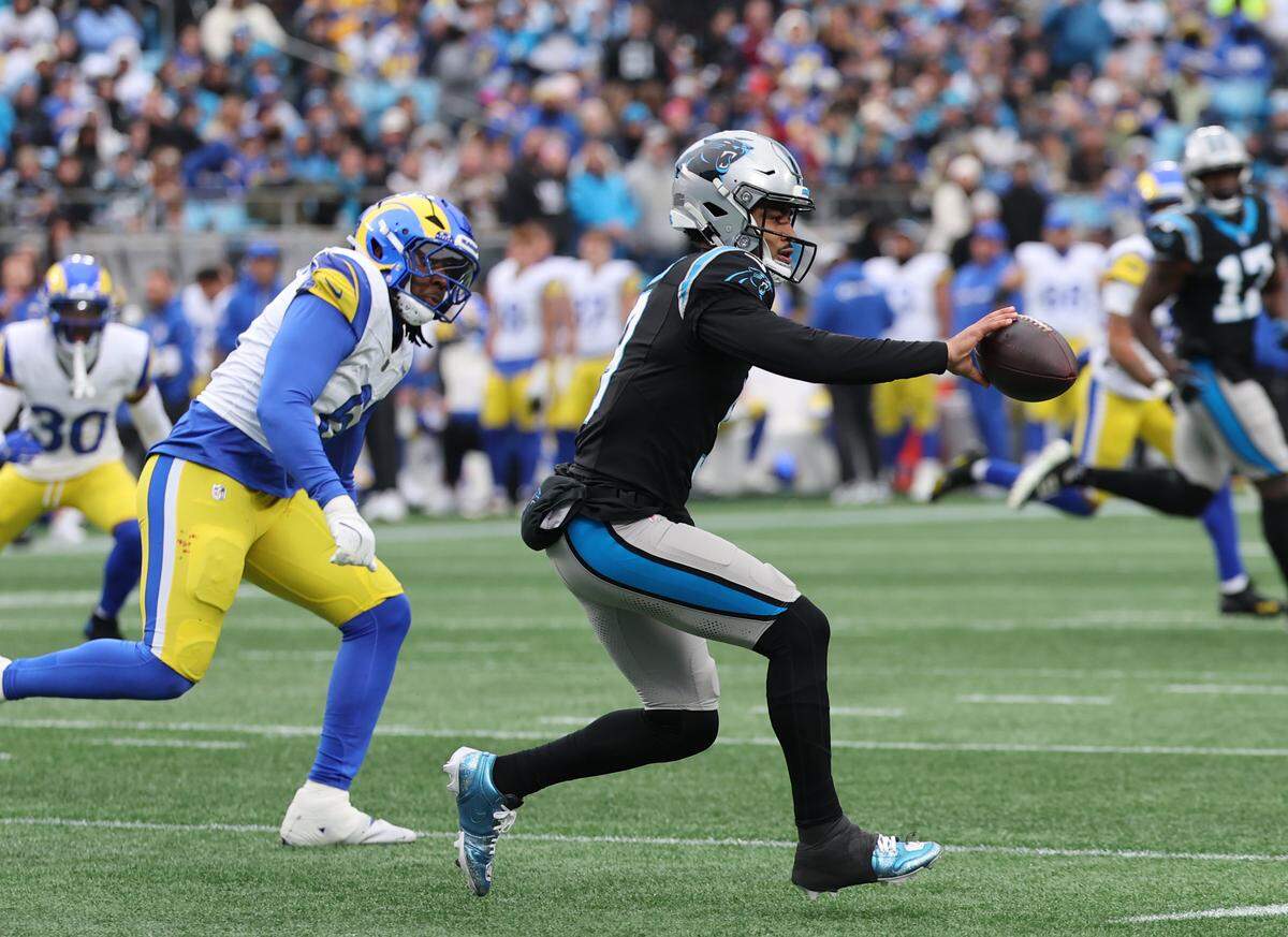 Carolina Panthers QB Bryce Young tosses the ball to Mitchell Evans on Nov. 30, 2025 at Bank of America Stadium.