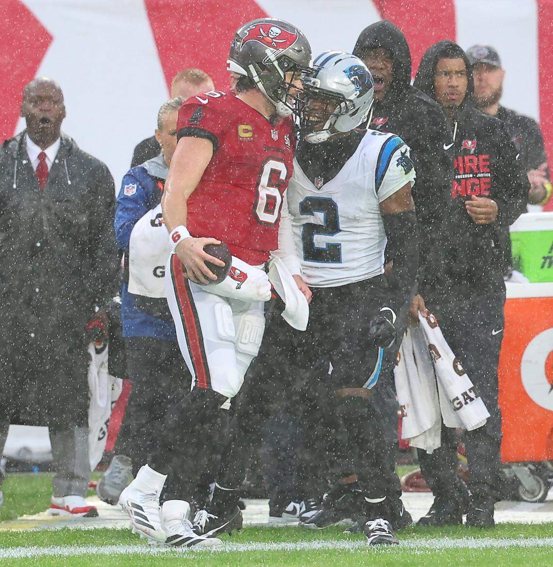 Carolina Panthers cornerback Mike Jackson, right, gets up close to Tampa Bay Buccaneers quarterback Baker Mayfield after Mayfield scrambled for a first down during action at Raymond James Stadium in Tampa, Florida, on Saturday, Jan. 3, 2026. The Buccaneers defeated the Panthers 16-14.
