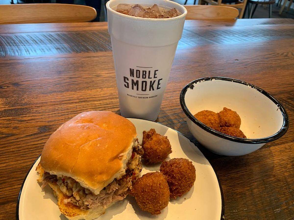 A pork sandwich and hush puppies at Noble Smoke.