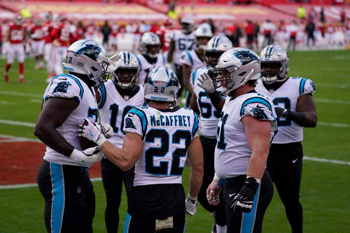 Carolina Panthers running back Christian McCaffrey (22) is congratulated by teammates after scoring against the Kansas City Chiefs Sunday. It was McCaffrey’s first game back after a six-week absence due to a high ankle sprain.