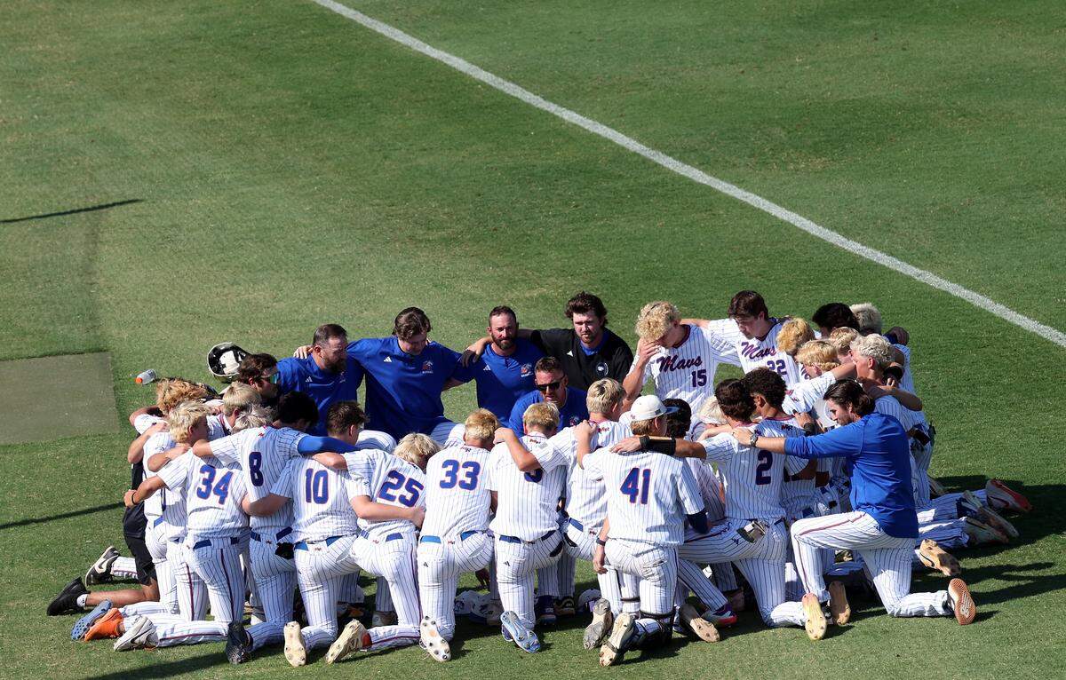 The Marvin Ridge Mavericks baseball team join together in prayer prior to action against Holly Springs in Game 1 of the NCHSAA 7A Baseball Championship at the Burlington Athletic Stadium on Friday, May 29, 2026 in Burlington, NC. Holly Springs defeated Marvin Ridge 3-1.