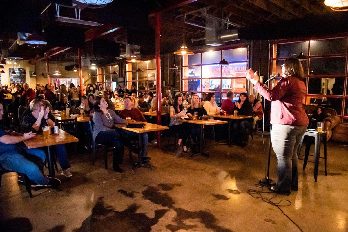 Lauren Ansley addresses a crowd at a comedy night at DreamChasers Brewery in Waxhaw. As a stand-up comedian Ansley owns Beerly Funny Productions and a second company. She produces shows, emcees, hosts events, and represents other area talent.