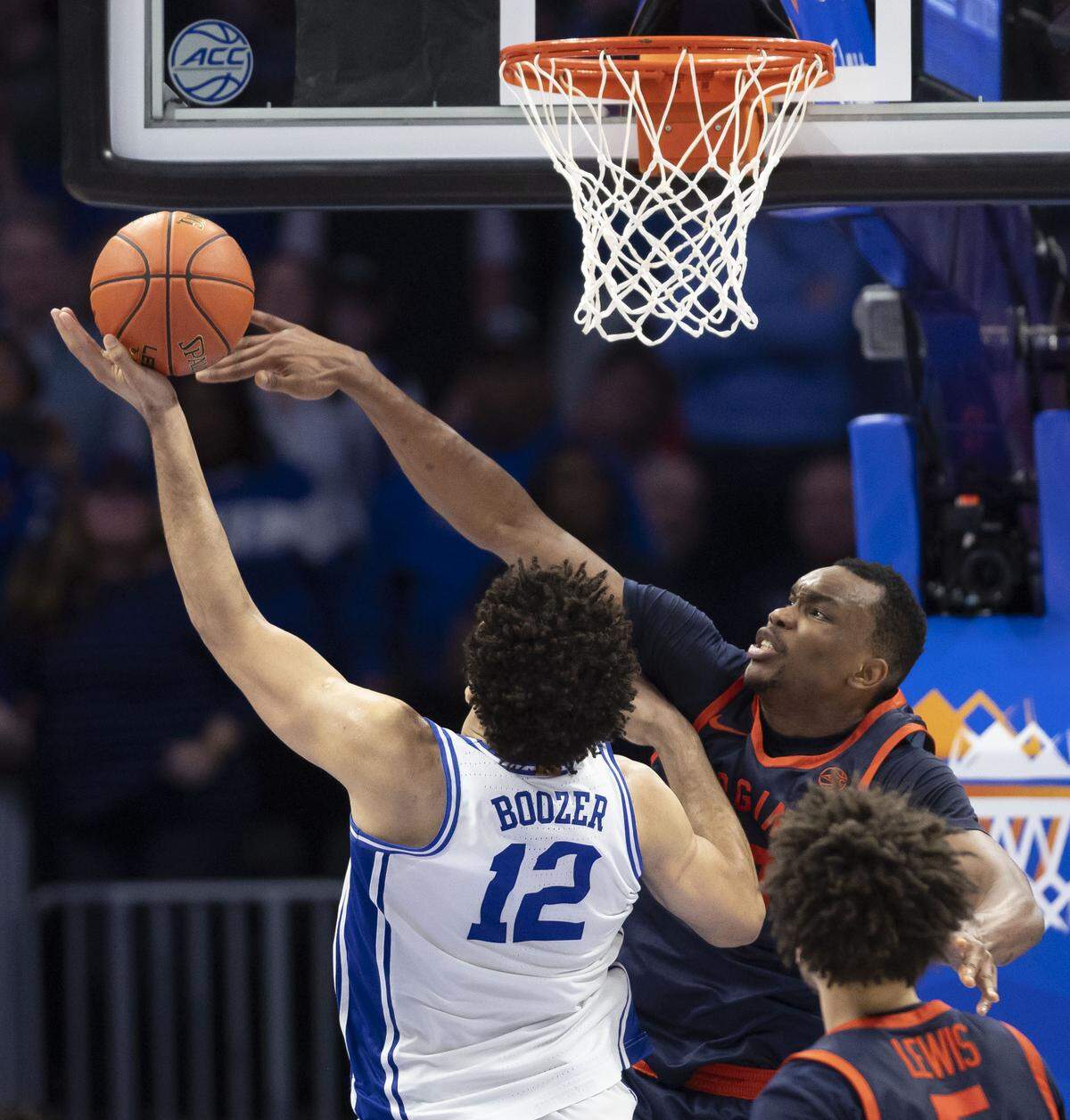 Virginia center Ugonna Onyenso (33) blocks a shot by Duke forward Cameron Boozer (12) in the second half Saturday. Onyenso had nine blocks in the game.