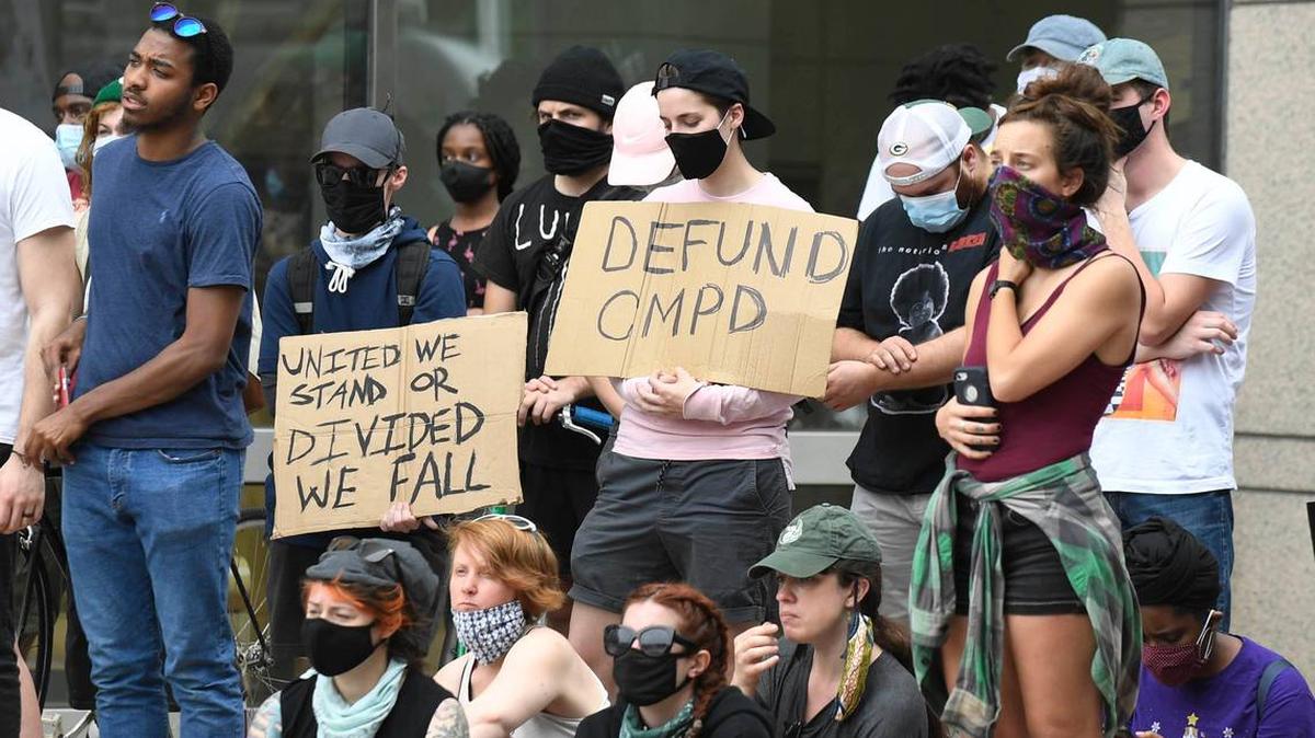 The crowd listens to a speaker at the Charlotte-Mecklenburg Government Center during protests Monday. Some protesters across the nation are calling for cities to defund the police. 