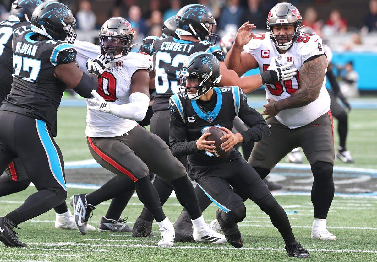 Carolina Panthers quarterback Bryce Young, center, looks to scramble to the far sideline during action against the Tampa Bay Buccaneers on Dec. 21, 2025 at Bank of America Stadium. The Panthers defeated the Buccaneers 23-20.