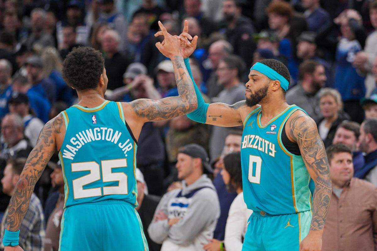 Charlotte Hornets forward P.J. Washington (25) and forward Miles Bridges (0) celebrate after the game against the Minnesota Timberwolves quarter at Target Center.
