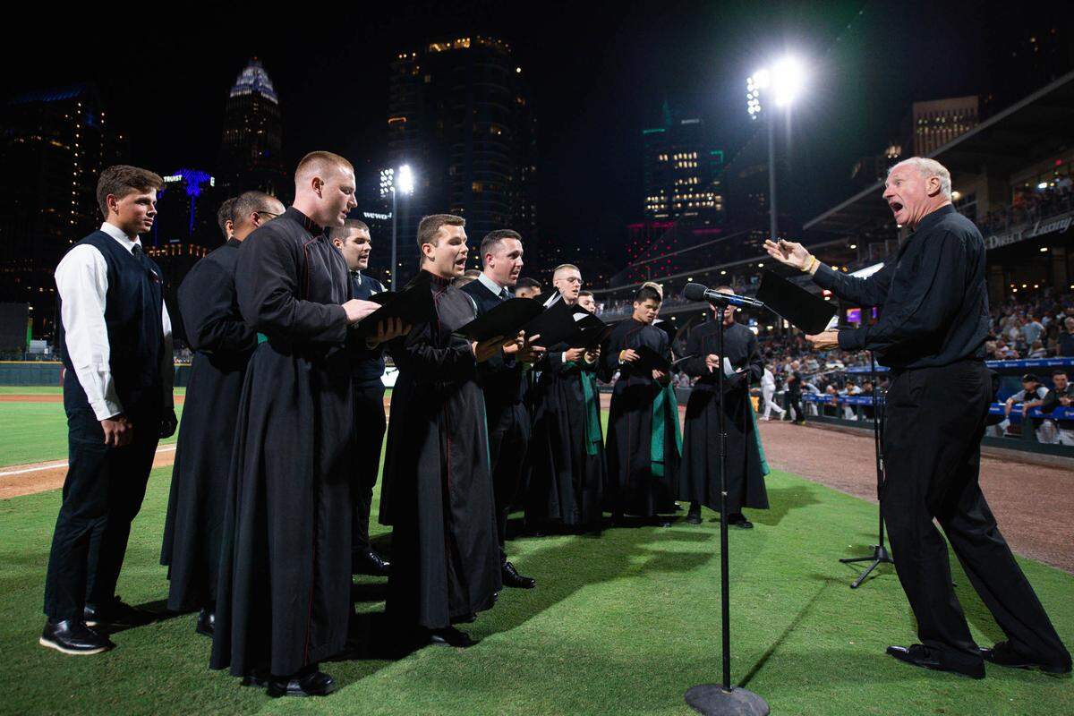 Tom Savoy leads a group of seminary students in a rendition of “Take Me Out to the Ball Game” at a Charlotte Knights game in September.