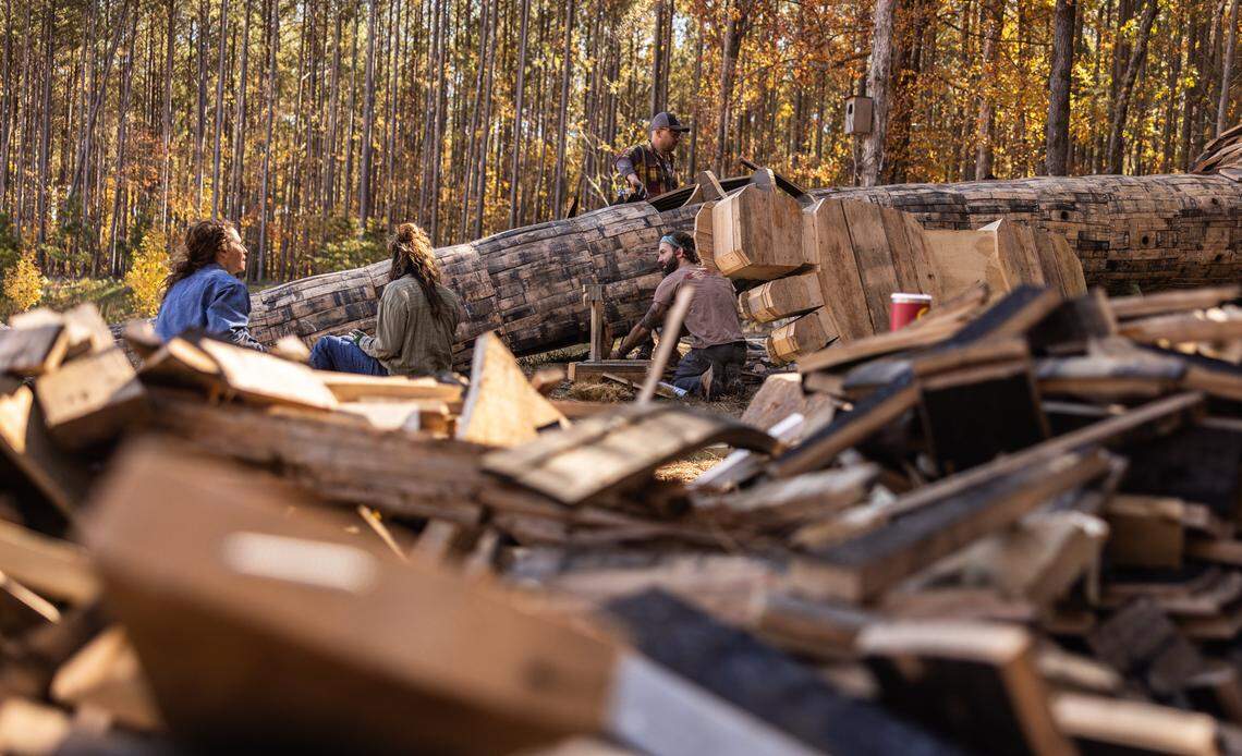 Volunteers work on constructing a giant troll sculpture named Pete with the Big Feet by Danish artist Thomas Dambo in Charlotte, N.C., on Thursday, November 6, 2025.