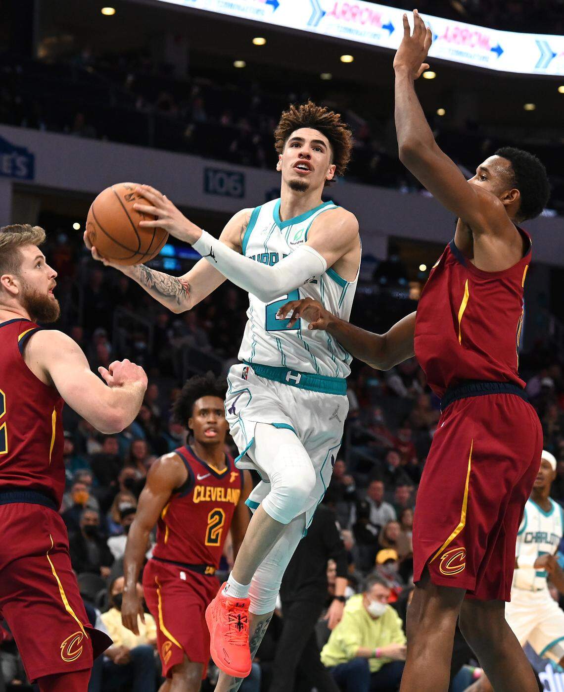 Charlotte Hornets guard LaMelo Ball, center, slices between two Cleveland defenders Monday. Ball is third in the NBA in made three-pointers (26).
