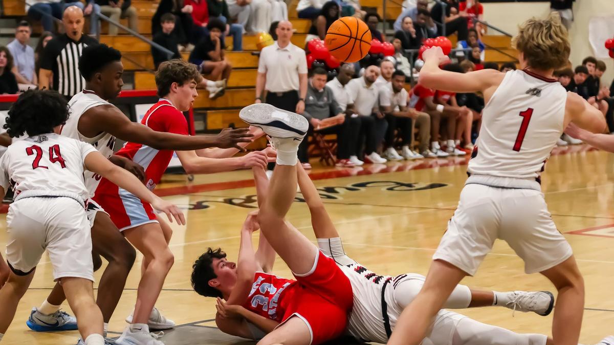 Charlotte Catholic Chris Eagen dives onto the hardwood for a crucial loose ball on February 7th, 2025 at Butler high school in Matthews, NC