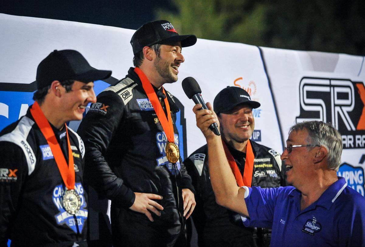 Winner Marco Andretti is interviewed by track announcer Todd Behling with runner-up Luke Fenhaus, left, and third-place Tony Stewart alongside at the Superstar Racing Experience event Saturday, July 10, 2021, at Slinger Speedway in Slinger, Wisconsin.