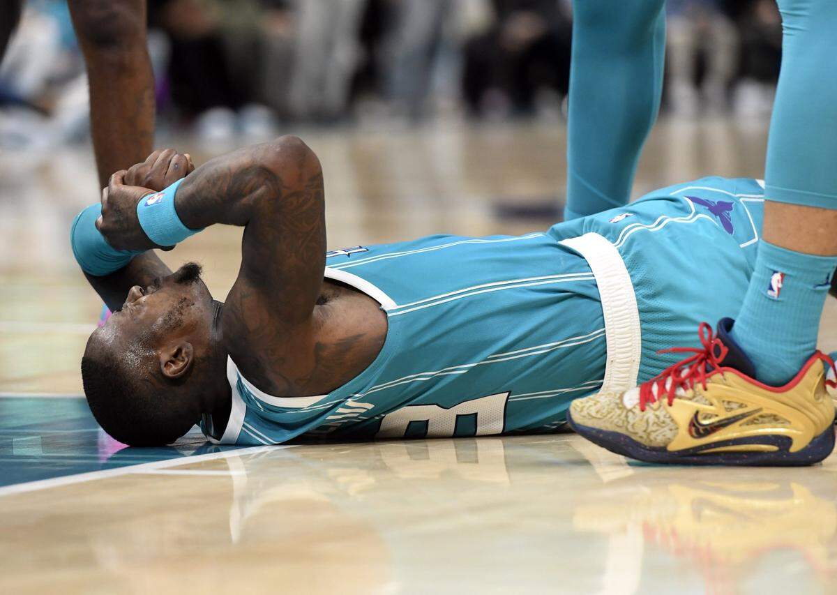 Dec 11, 2023; Charlotte, North Carolina, USA; Charlotte Hornets guard Terry Rozier (3) lays on the court after a hard fall during the second half against the Miami Heat at the Spectrum Center. Mandatory Credit: Sam Sharpe-USA TODAY Sports