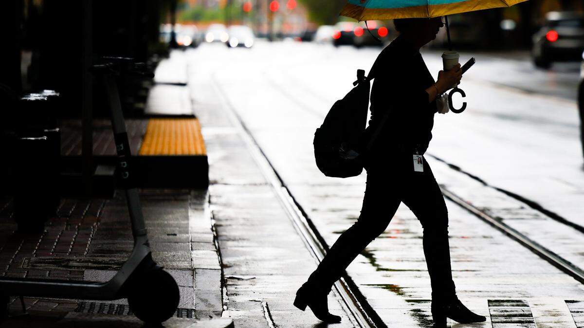 Power outages are expected as severe thunderstorms move through the Charlotte area Monday, Aug. 15. A woman crossing the intersection of North Tryon and East Trade streets under an umbrella as rainfalls in uptown Charlotte, NC, on Thursday, April 7, 2022.