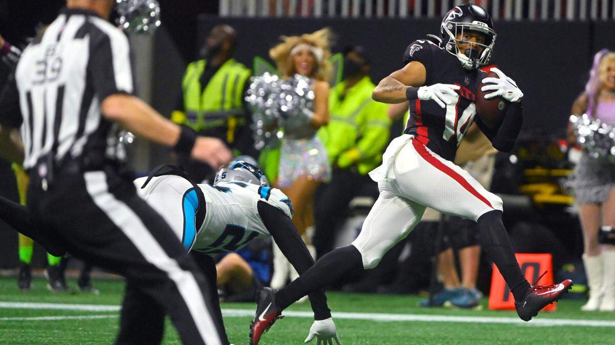 Atlanta Falcons wide receiver Damiere Byrd, right, slips past Carolina Panthers safety Xavier Woods (25) defender after catching a 47-yard pass for a touchdown during the second half of an NFL football game Sunday, Oct. 30, 2022, in Atlanta. (AP Photo/John Amis)