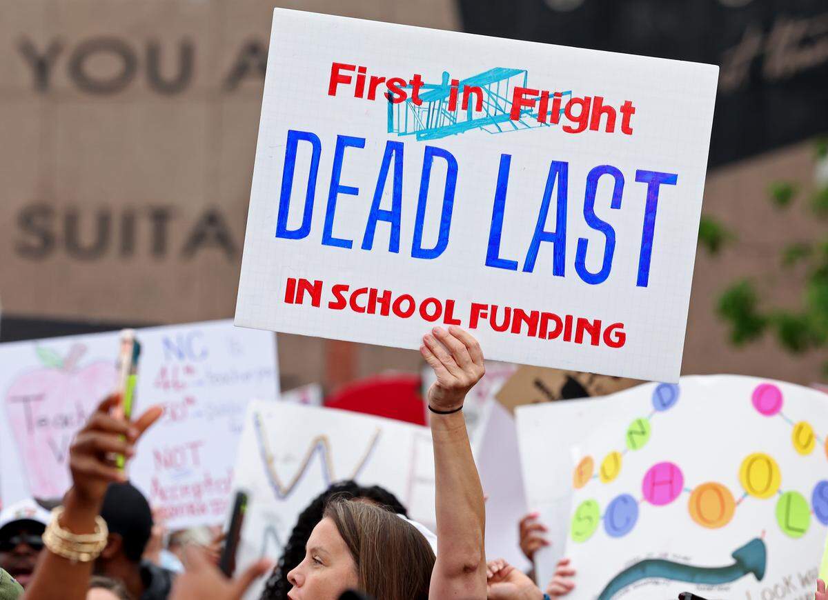 Signs, signs, signs were everywhere as teachers rallied at the Government Complex in Raleigh.
