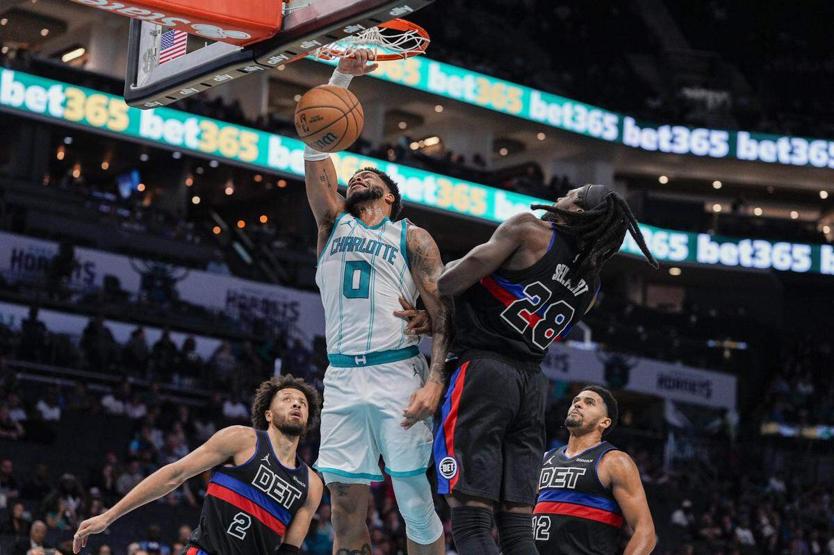 Charlotte Hornets forward Miles Bridges (0) goes up for a dunk against Detroit Pistons center Isaiah Stewart (28) during the second half at Spectrum Center.