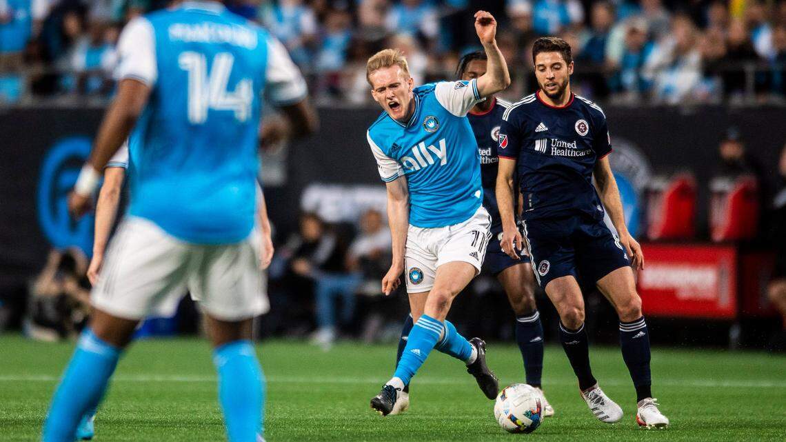 Charlotte FCs Karol Swiderski, center, cries out as he passes the ball during the game against New England at Bank of America Stadium on Saturday, March 19, 2022 in Charlotte, NC.