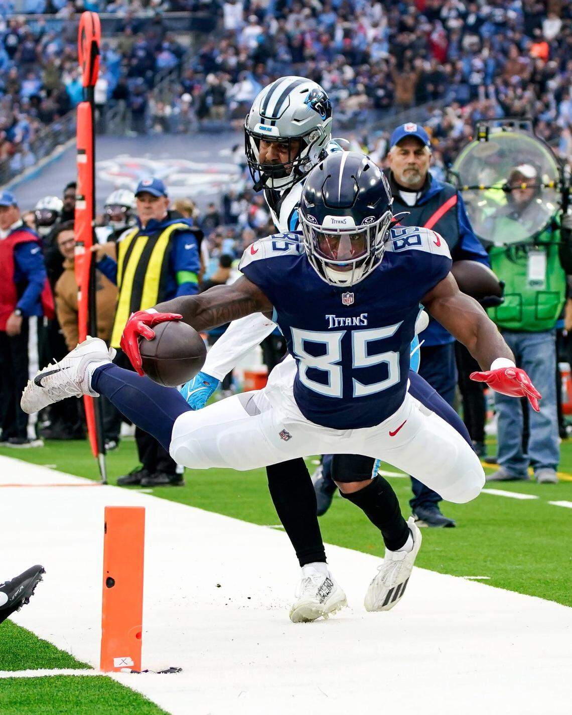 Tennessee Titans tight end Chigoziem Okonkwo (85) is pushed out of bounds at the 1-yard line by Carolina Panthers linebacker Kamu Grugier-Hill (54) during the first quarter at Nissan Stadium in Nashville, Tenn., Sunday, Nov. 26, 2023.