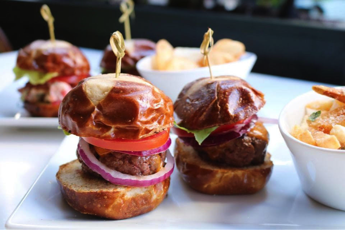 Reid’s Fine Foods’&nbsp;uptown location on Levine of the Arts Avenue includes a patio, where you can order two sliders and fries for $10
