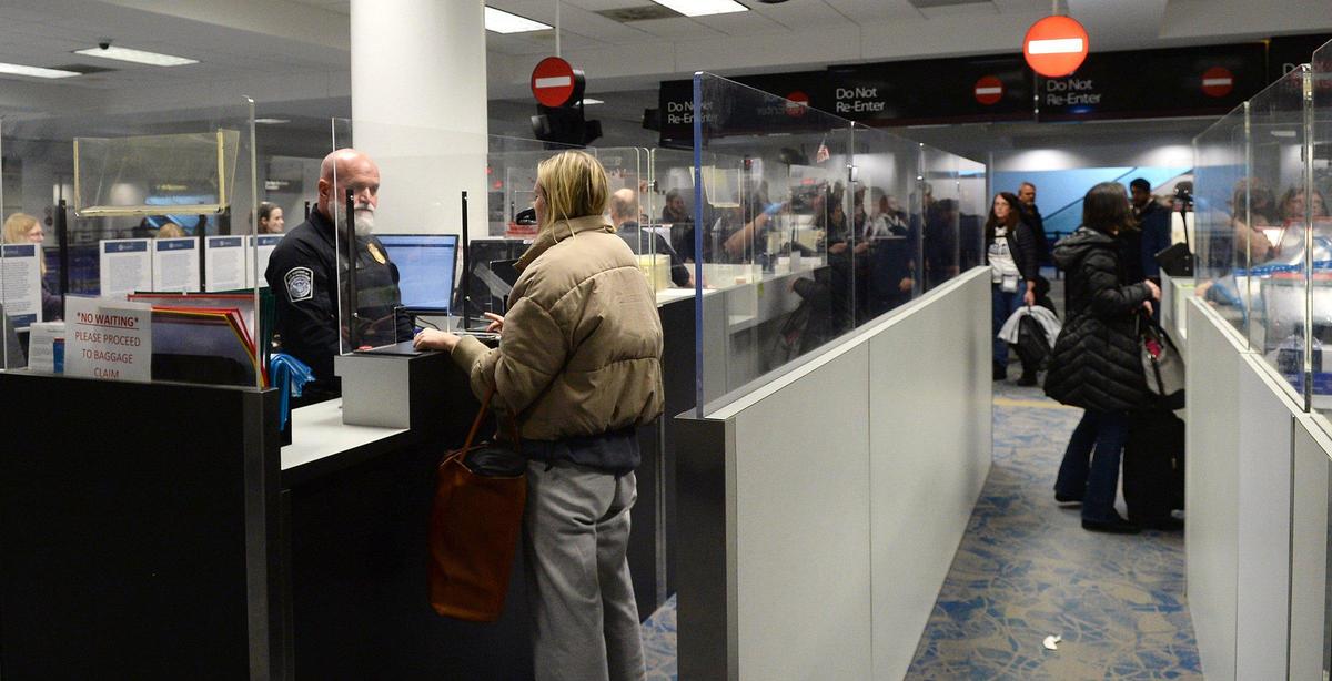 An officer with the U.S. Customs and Border Protection at Charlotte Douglas International Airport clears a passenger at the International Port of Entry. CBP officers showcased the latest facial comparison technology and new International Travel smart phone applications that can potently speed up a traveler’s entry into the U.S.