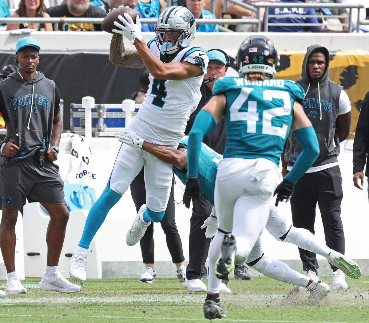 Carolina Panthers wide receiver Tetairoa McMillan, left, catches a pass from quarterback Bryce Young as the Jacksonville Jaguars closes in during action on Sunday, September 7, 2025 at Everbank Stadium in Jacksonville, Florida. The Jaguars defeated the Panthers 26-10.