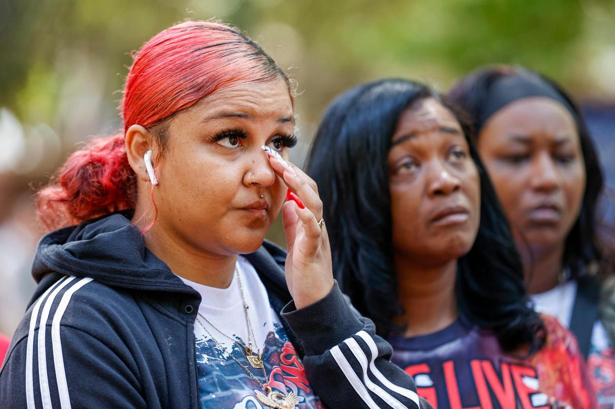 Cree Faulkner, left, wipes away tears as she and J’on Staton, center, stand at a press conference about Malcolm Staton at the Union County Courthouse in Monroe, N.C., Friday, April 29, 2022. Malcom Staton was a 30-year-old father who was shot and killed by a Union County Sheriff’s deputy March 15 with children in the car. (photo: Nell Redmond)