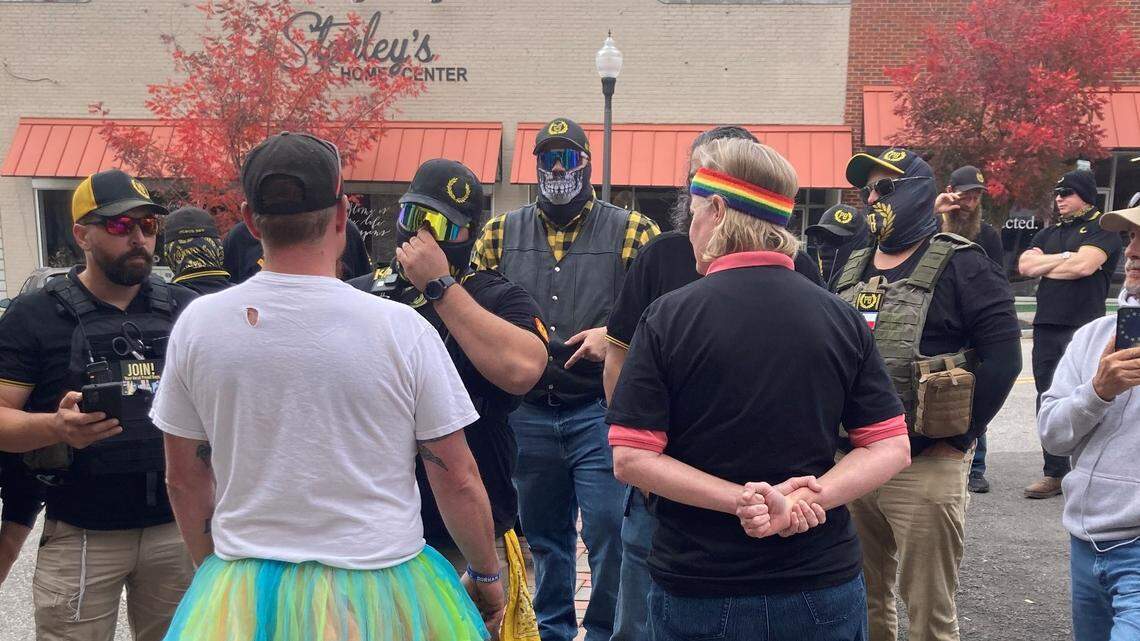A drag brunch fundraiser Oct. 30, 2022 in Sanford, NC was disrupted by masked Proud Boys protesters. This photo, taken by event organizer Lindsey Knapp, shows two counter protesters talking with a group of Proud Boys. The brunch raised money for sex assault survivors and an LGBTQ resource center.