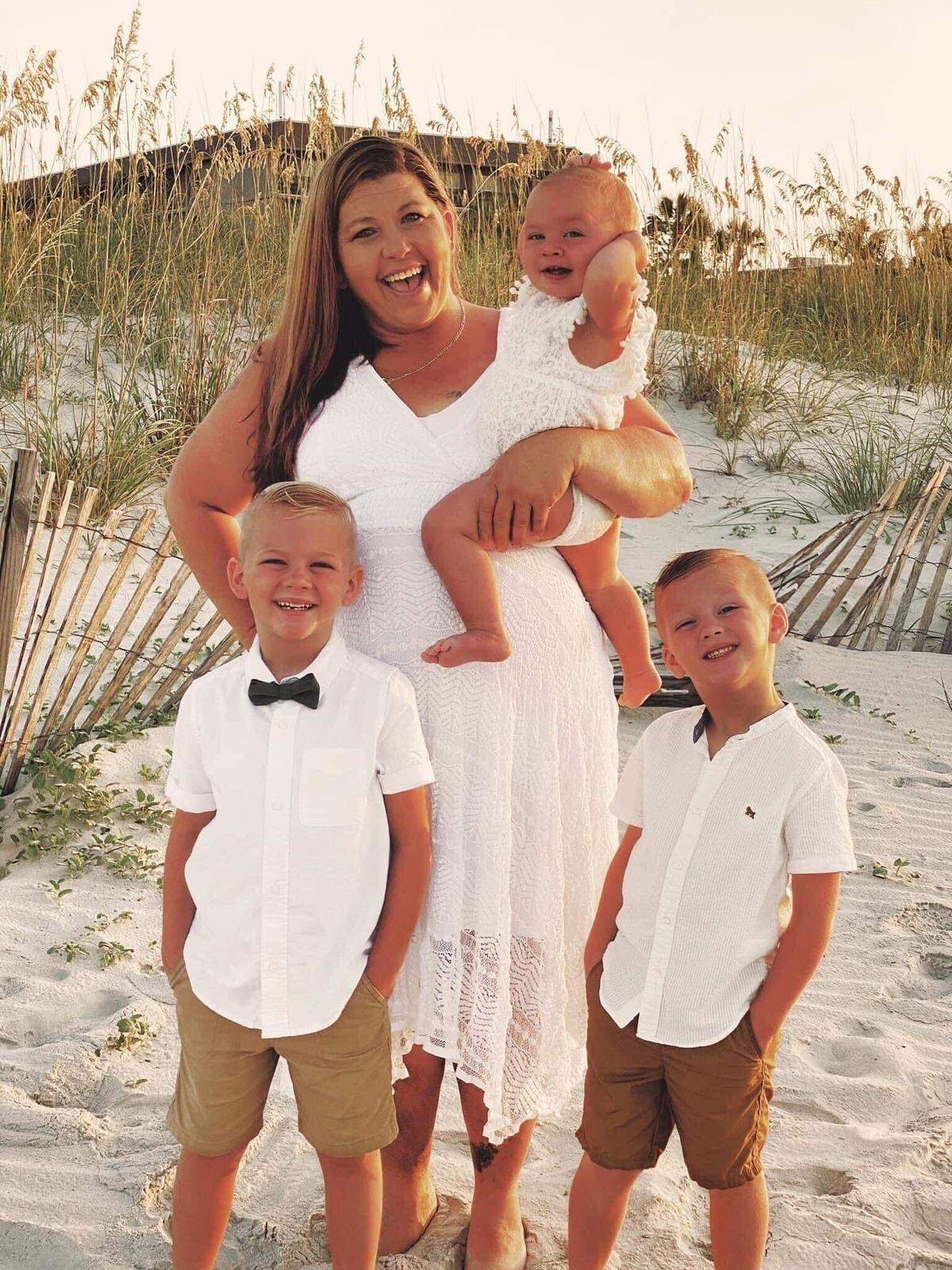 In this photo provided by her son, Karen Baker enjoys beach time with her grandchildren. Baker, 48, died after a shooting in Charlotte, NC, on Wednesday, July 13, 2022.