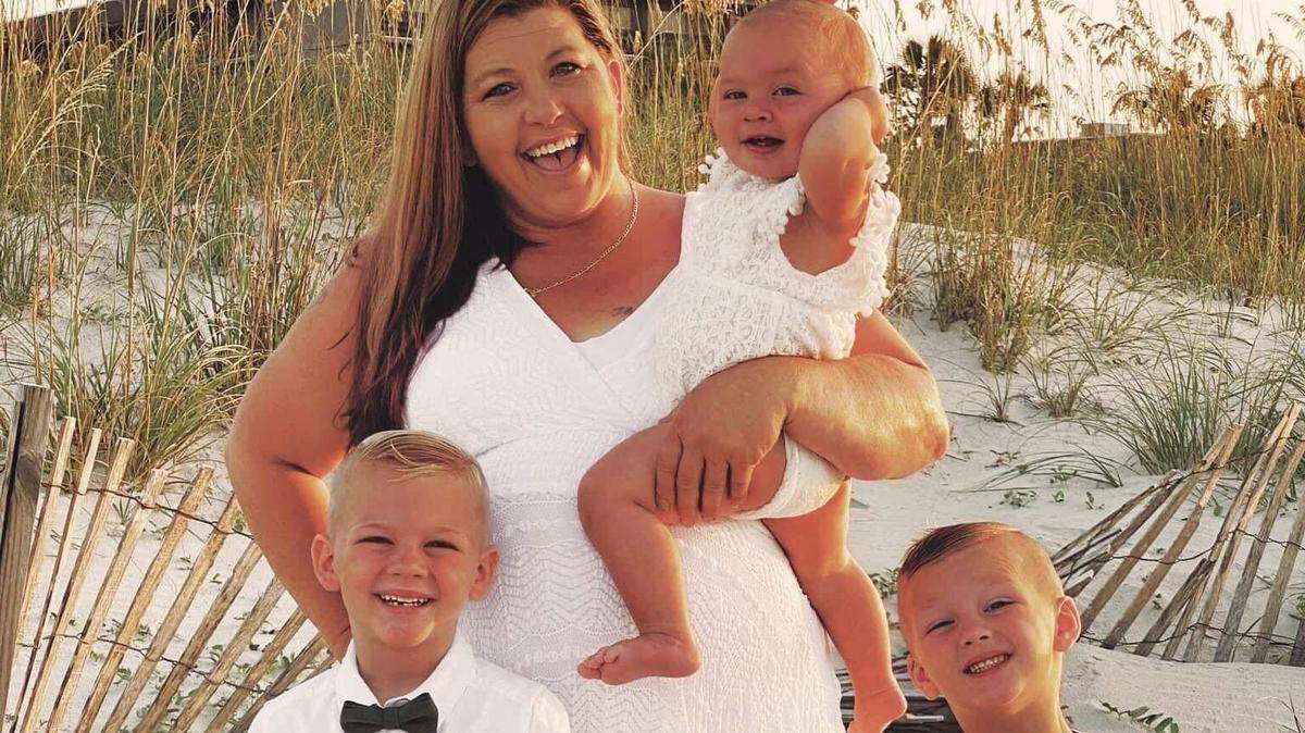 In this photo provided by her son, Karen Baker enjoys beach time with her grandchildren. Baker, 48, died after a shooting in Charlotte, NC, on Wednesday, July 13, 2022.