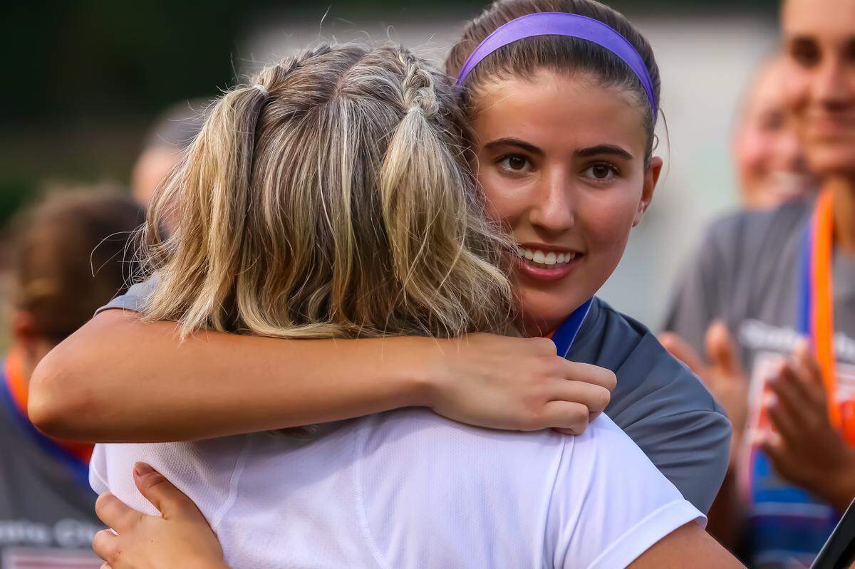 Ardrey Kell’s Ellie Riechman hugs her coach, Kim Montgomery, after receiving MVP at the NCHSAA 4A state championship game in Matthews NC at the Sportsplex on May 31. 2025