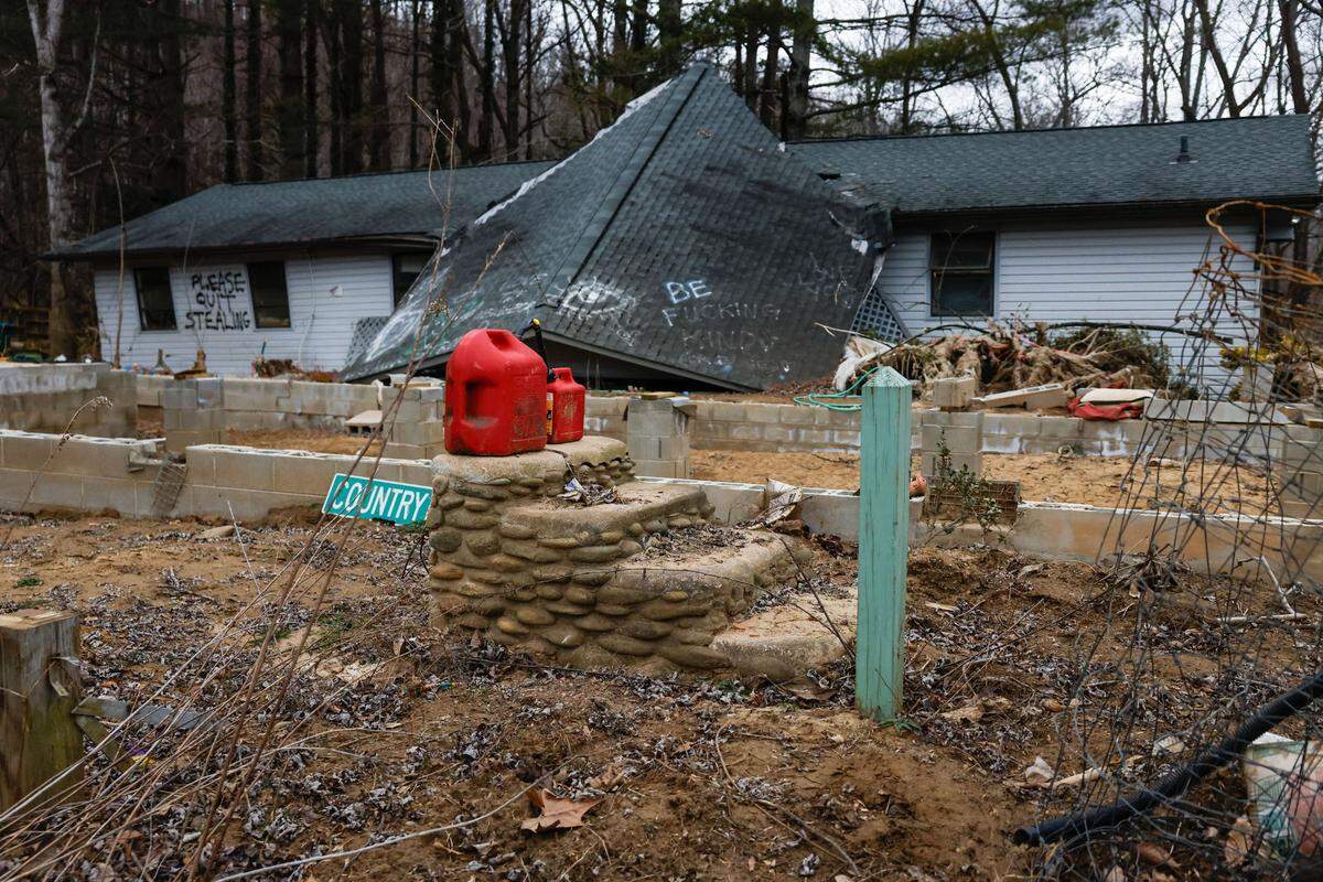 A gas canister sitsatop steps that used to lead to the front porch of Sabrina Mills’Swannanoa home, which was moved off of its foundation by flood waters.