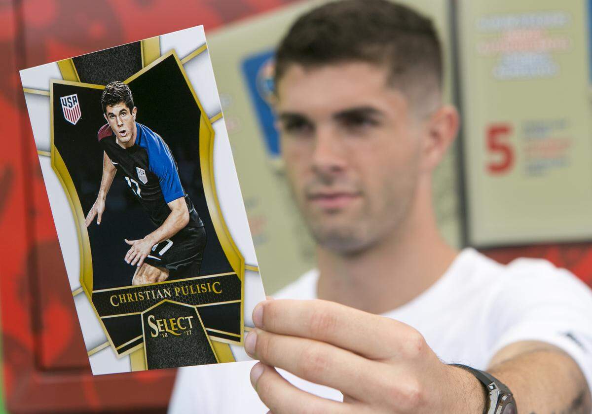 IMAGE DISTRIBUTED FOR PANINI AMERICA - US Soccer star Christian Pulisic shows off his own trading card at the Panini America Mobile Tour at a special youth soccer clinic put on by Panini America and Hershey in his hometown of Hershey, Pa. on Thursday, June 28, 2018. (Mark Stehle/AP Images for Panini America)