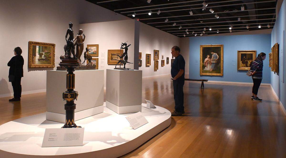 Mint Museum Uptown patrons check out the sculptures and paintings in the “American Made: Paintings and Sculpture from the Demell Jacobsen Collection.” The exhibition runs until Dec. 24.