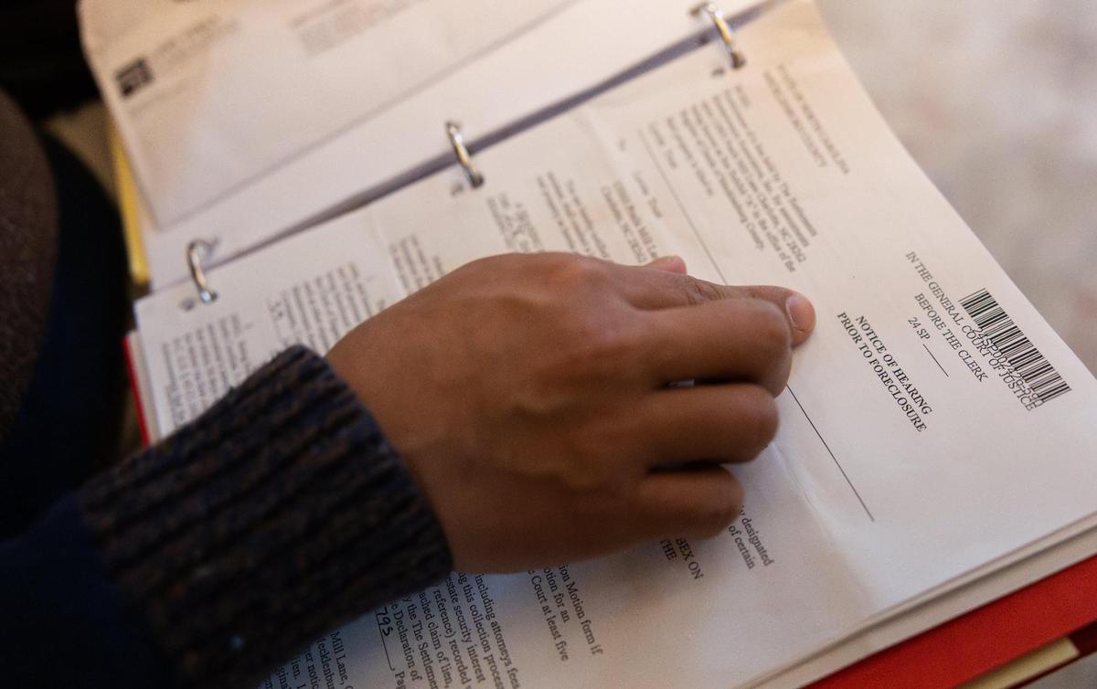 Jeffrey Baldwin points to a notice of foreclosure in his documents about a legal battle with his HOA in Charlotte, N.C., on Monday, January 6, 2025.